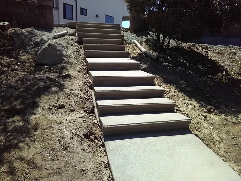 Poured concrete steps and landing down a slope