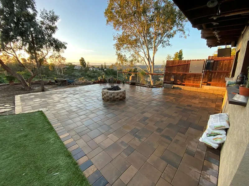 Paver patio with a block fire pit at sunset
