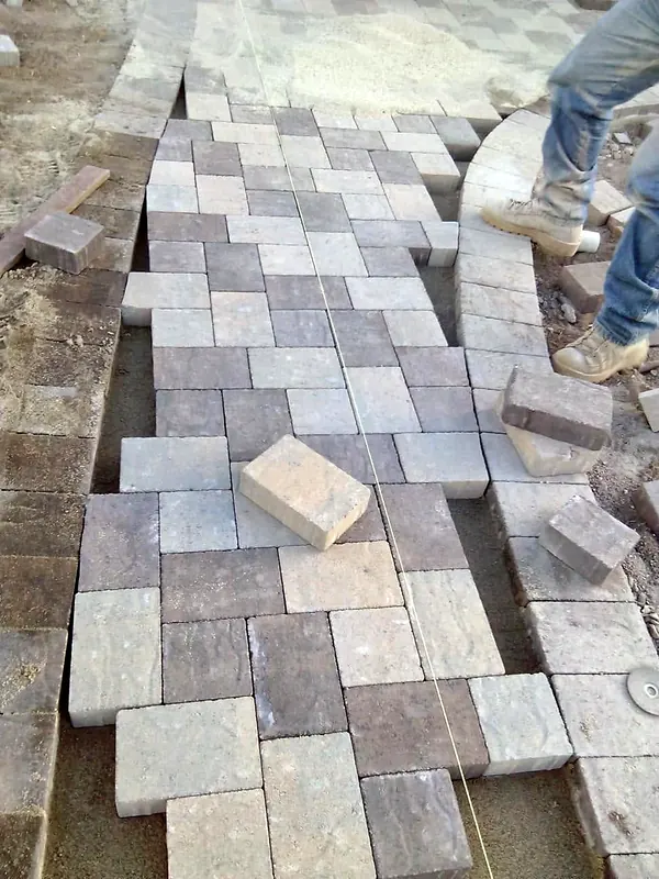 Pavers being laid by hand