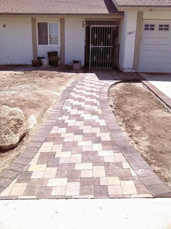 Paver walkway curving to a front entry