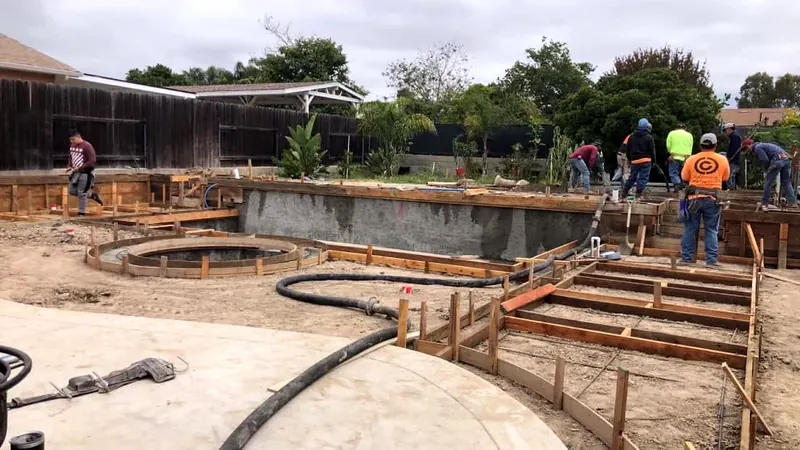 Crew forming a pool deck and stepping pads