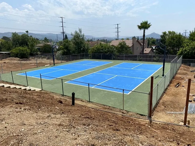Fenced pickleball and sport court on a concrete pad