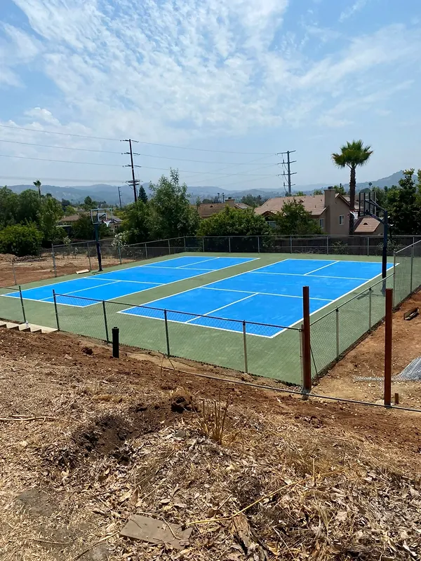 Fenced pickleball and sport court on a concrete pad