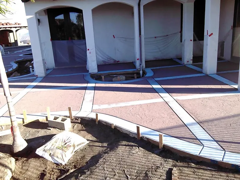 Stamped concrete panels with smooth bands, forms still in place