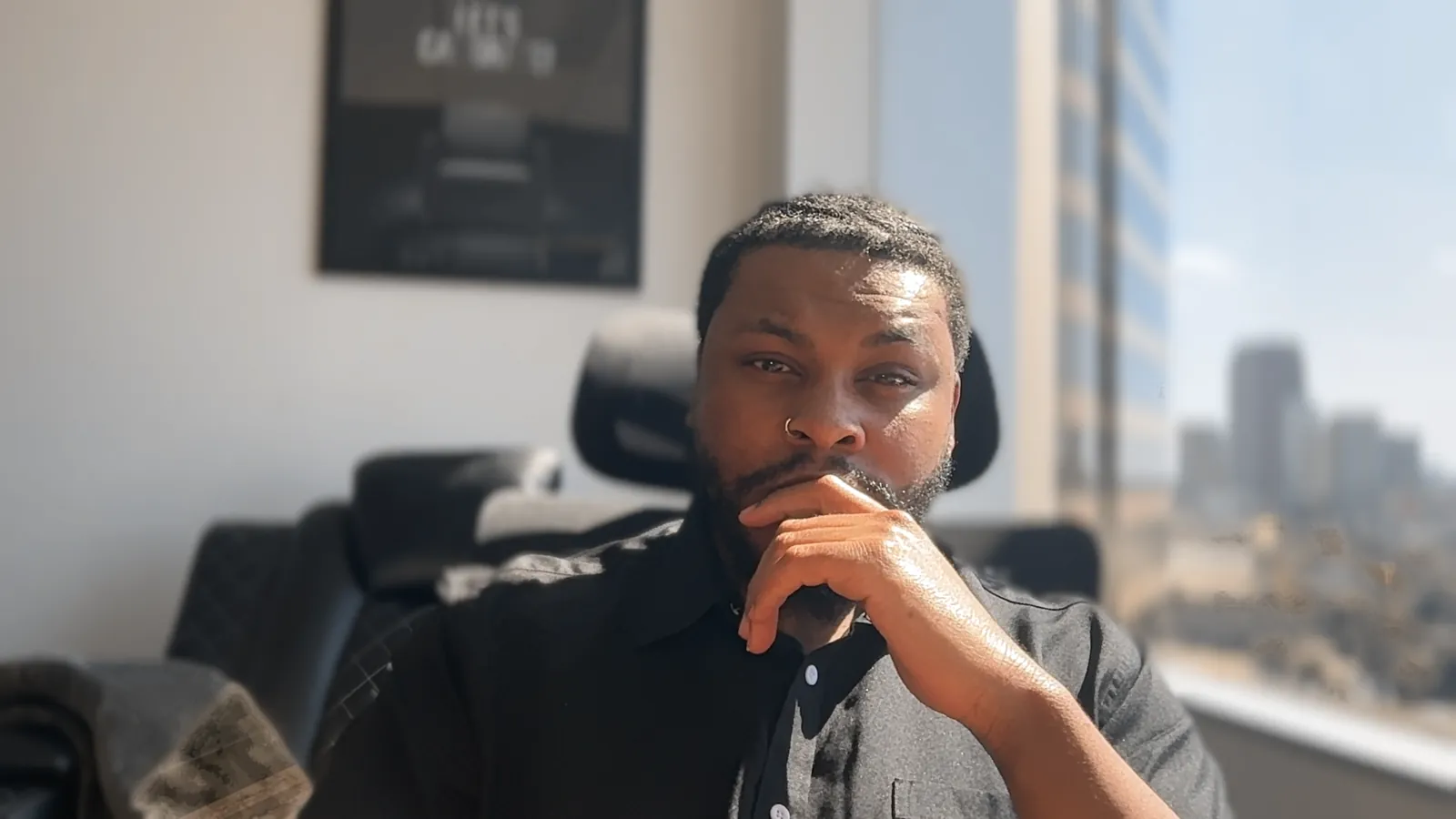 Jay Shaw, CHt, thinking, hand on chin, in his office