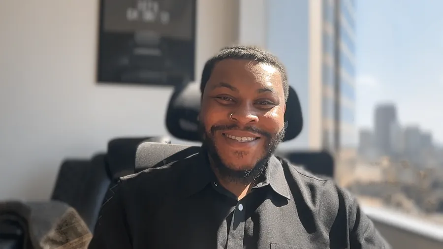 Jay Shaw, CHt, smiling in his office