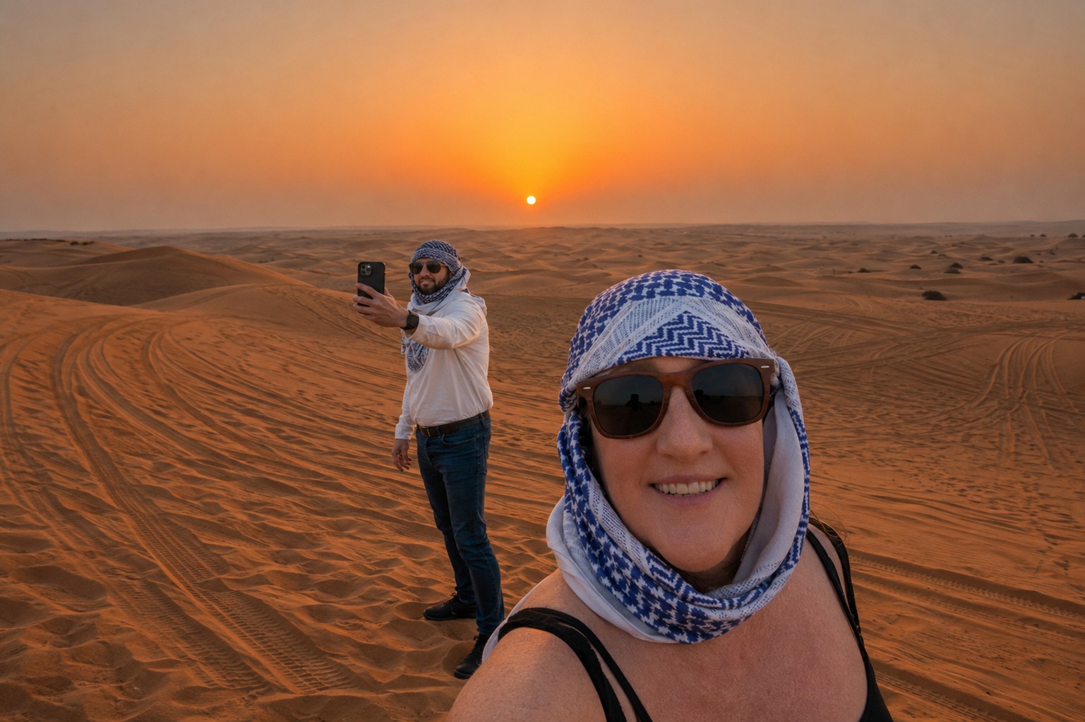 Billie and Matt in the desert outside Dubai at sunset