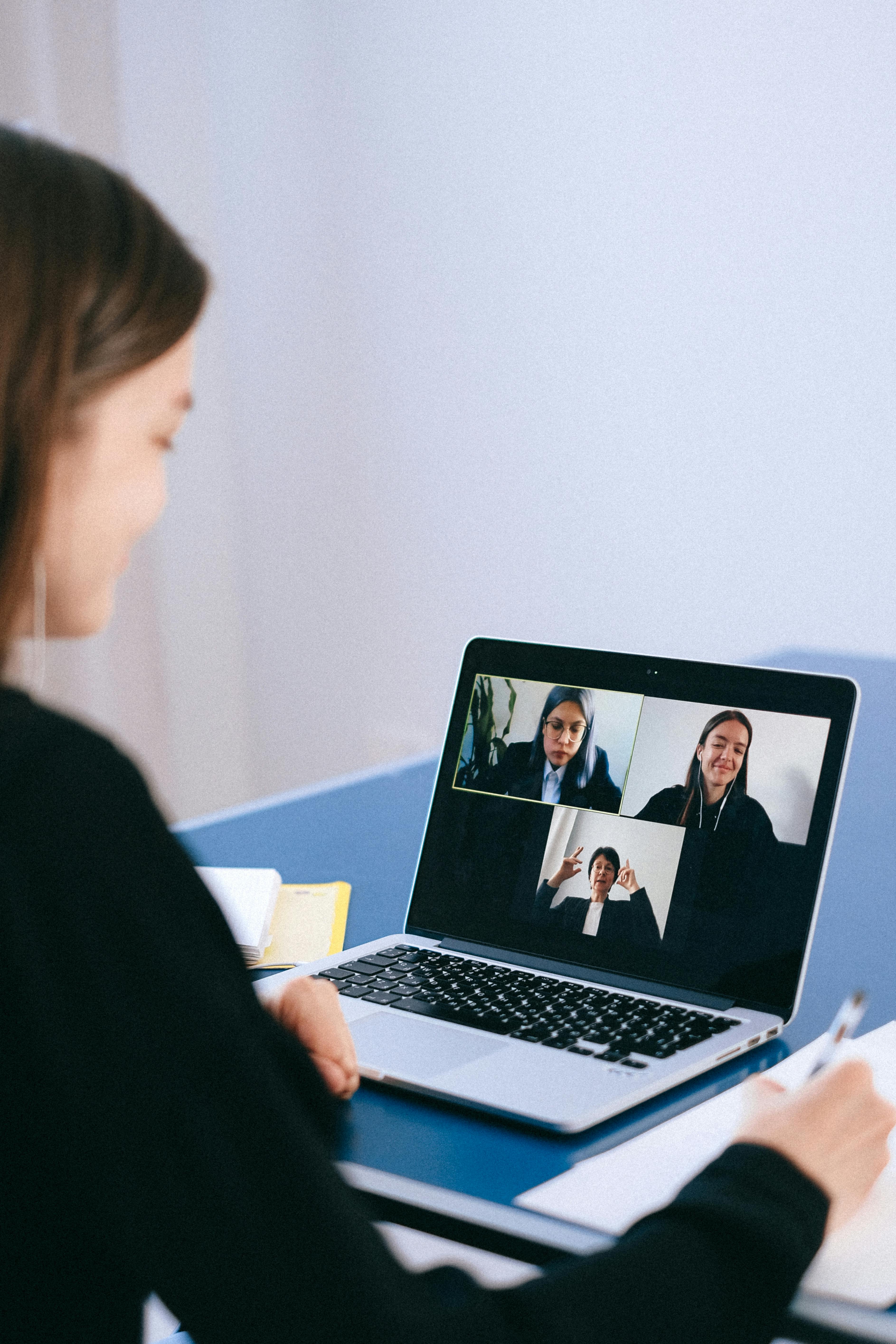 Business professionals communicating during an online meeting.
