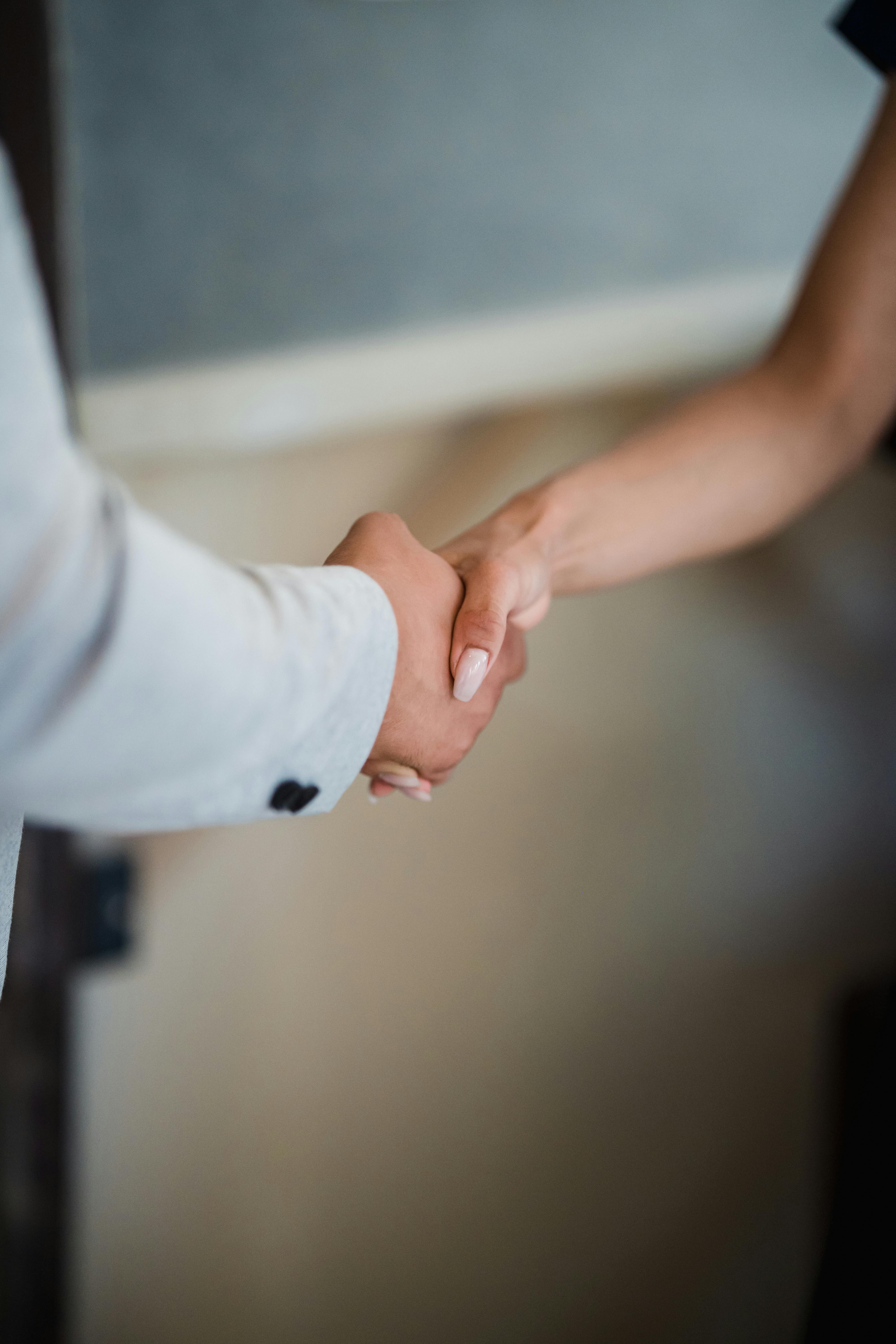 Two people shake hands in a professional setting, conveying the beginning of a trusted working partnership Placement: After the paragraph ending "And the thinking is the part that makes the activity work" Two people shake hands in a professional setting, conveying the beginning of a trusted working partnership Placement: After the paragraph ending "And the thinking is the part that makes the activity work"
