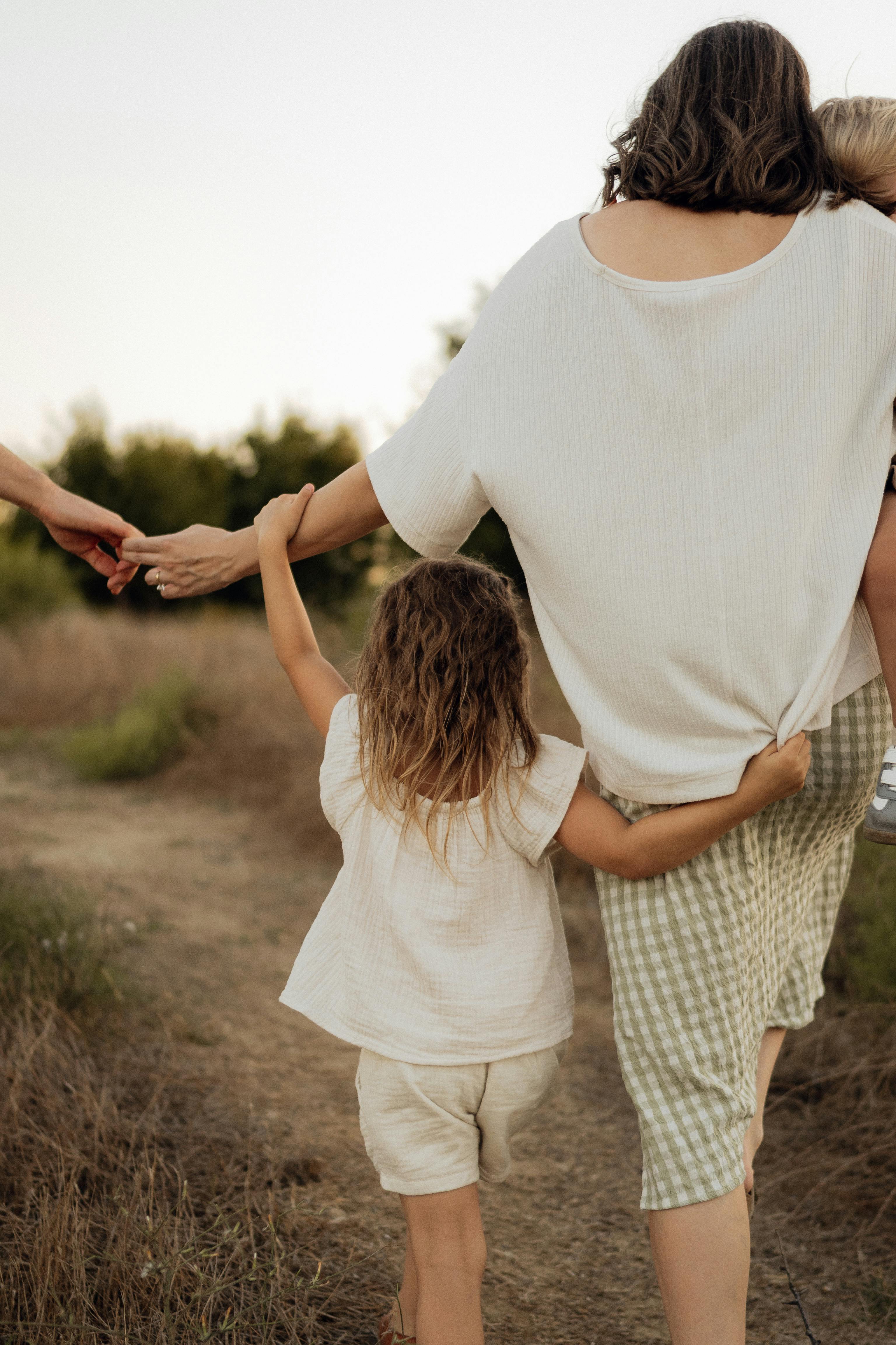 A mother walking with her children outdoors, representing the freedom that comes from having a properly built funnel working in the background while you focus on what matters most A mother walking with her children outdoors, representing the freedom that comes from having a properly built funnel working in the background while you focus on what matters most
