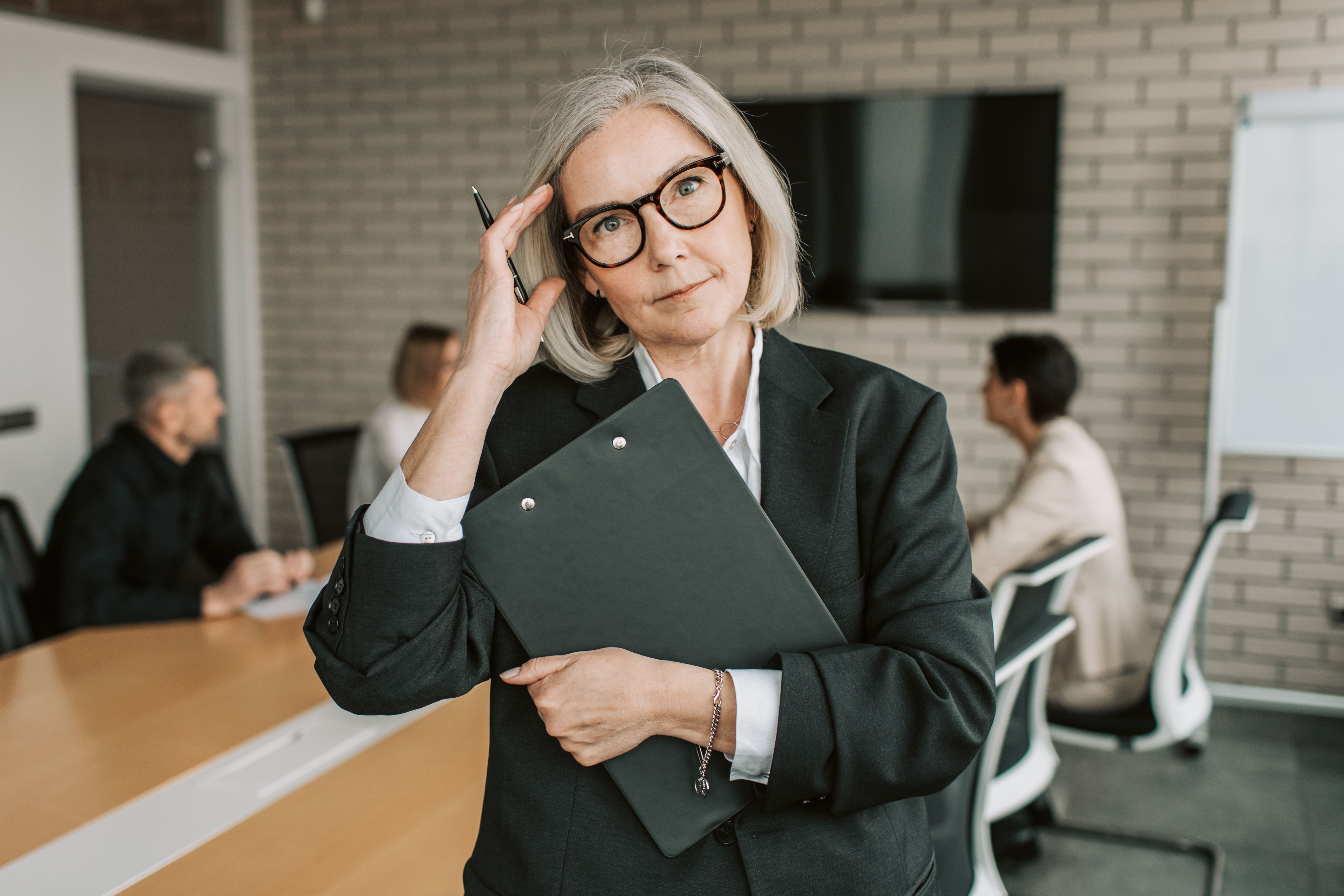 An experienced professional holding a clipboard and pen, looking forward with quiet authority, representing the investigative approach behind the quiz.