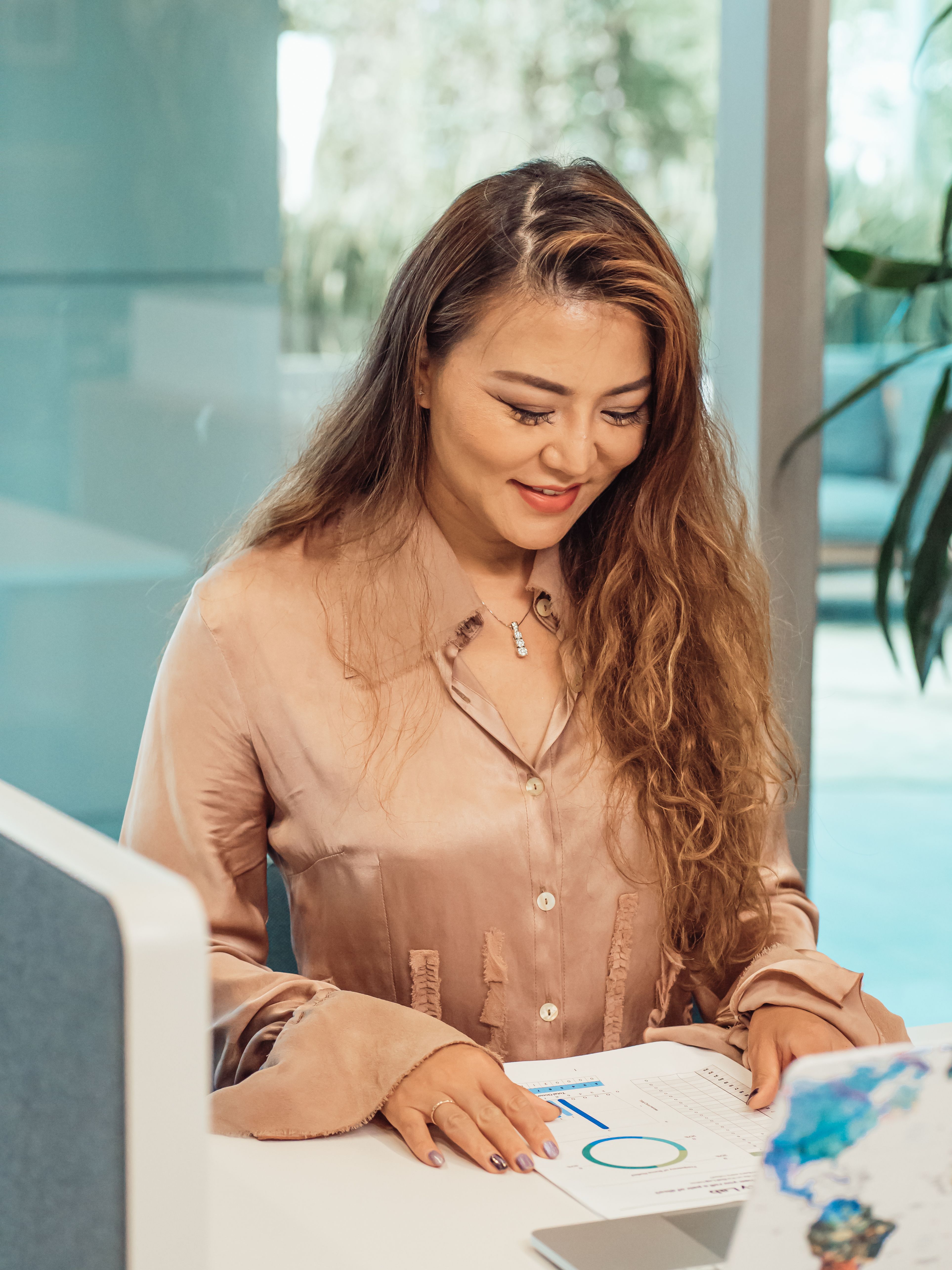 A business owner reviewing a structured report with quiet confidence, representing the moment of knowing exactly where your business stands after a Brand Alignment Audit.