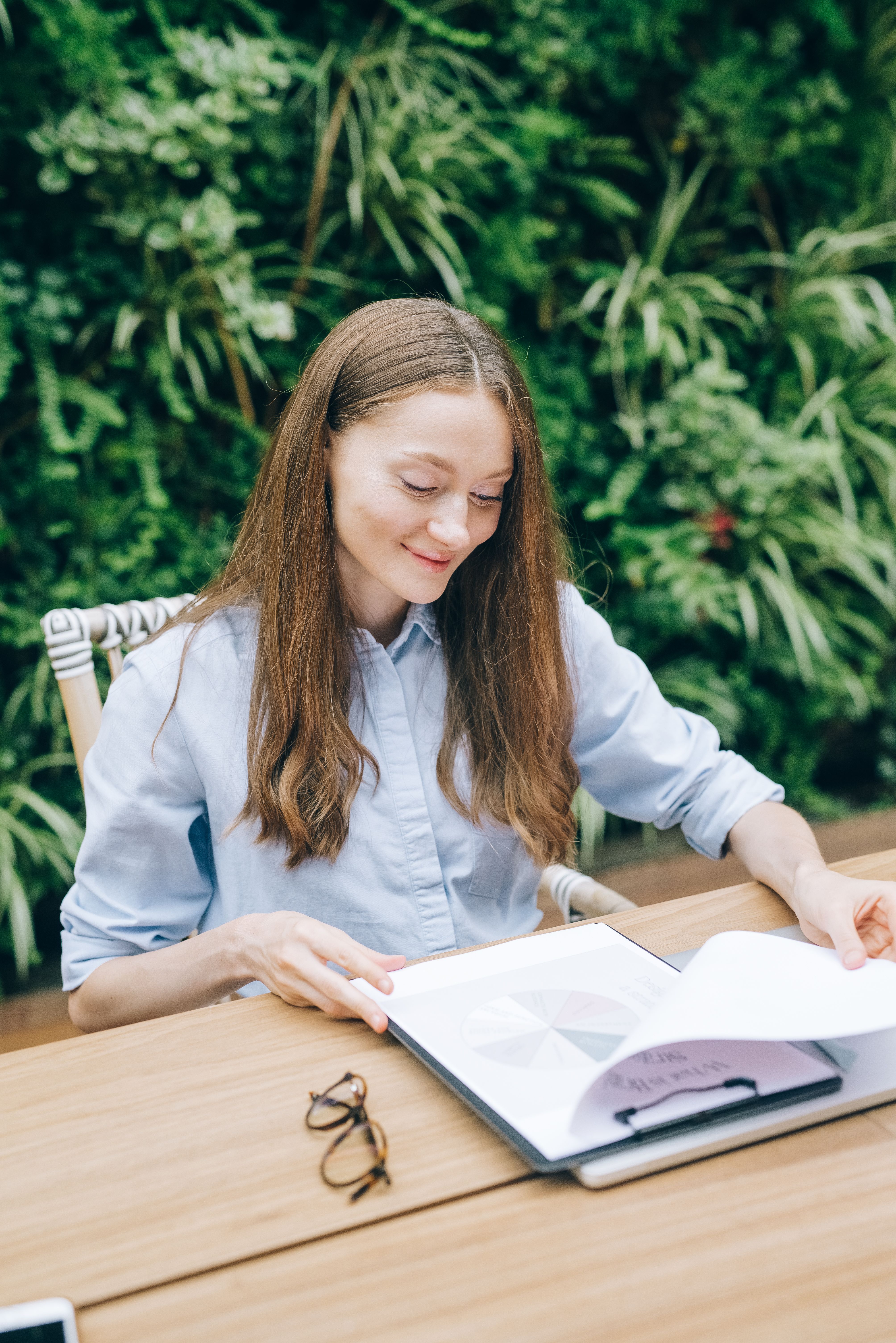 A business owner reading carefully through a brand document, representing the deliberate investment in getting brand foundations documented properly so every future decision has a clear reference to draw from.