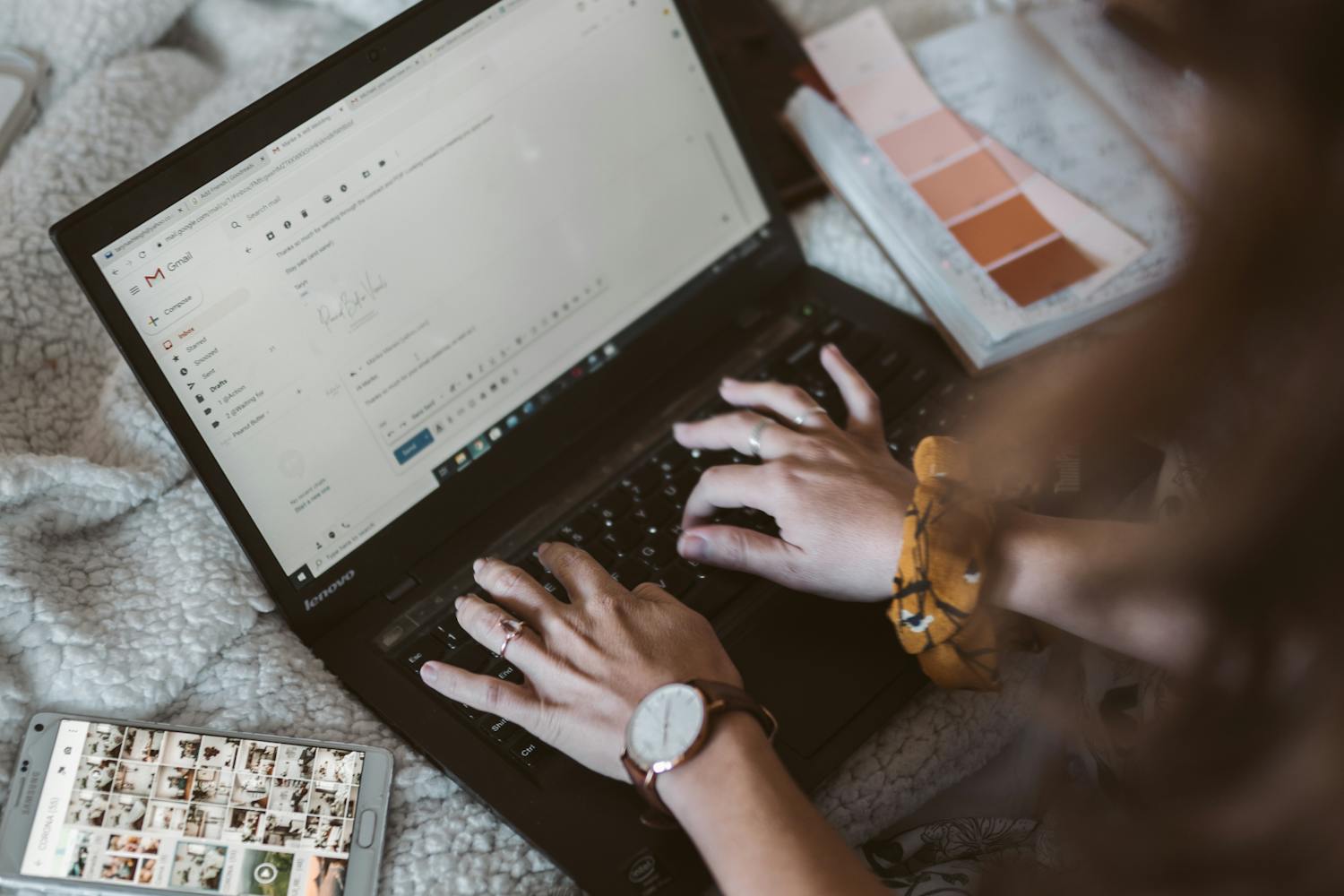 person working on laptop computer, hands typing on keyboard
