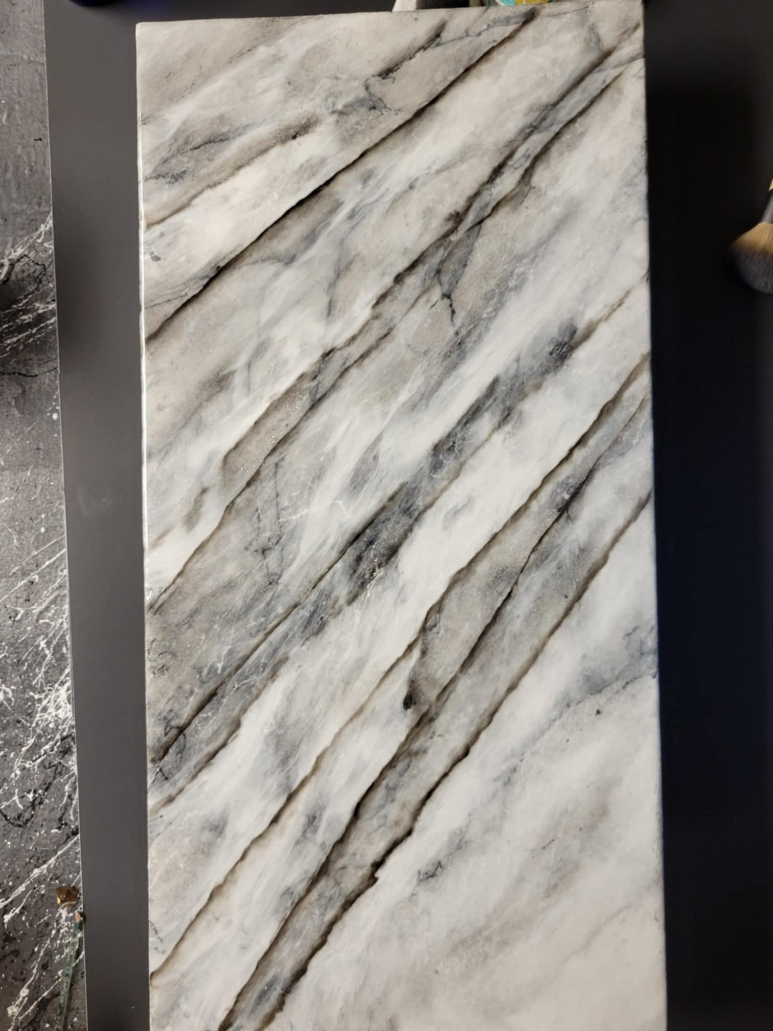 Custom marble-inspired resin sample with realistic veining by Resin Quarry Customs