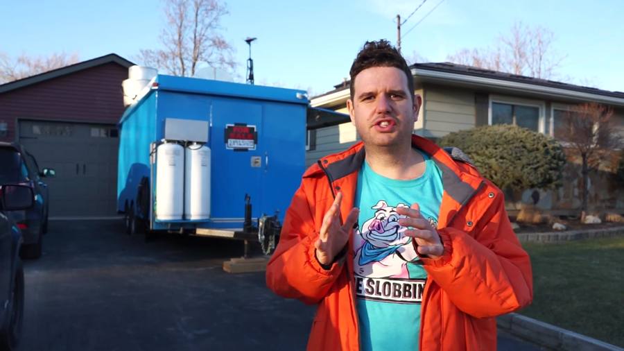 Joe in front of a blue food trailer
