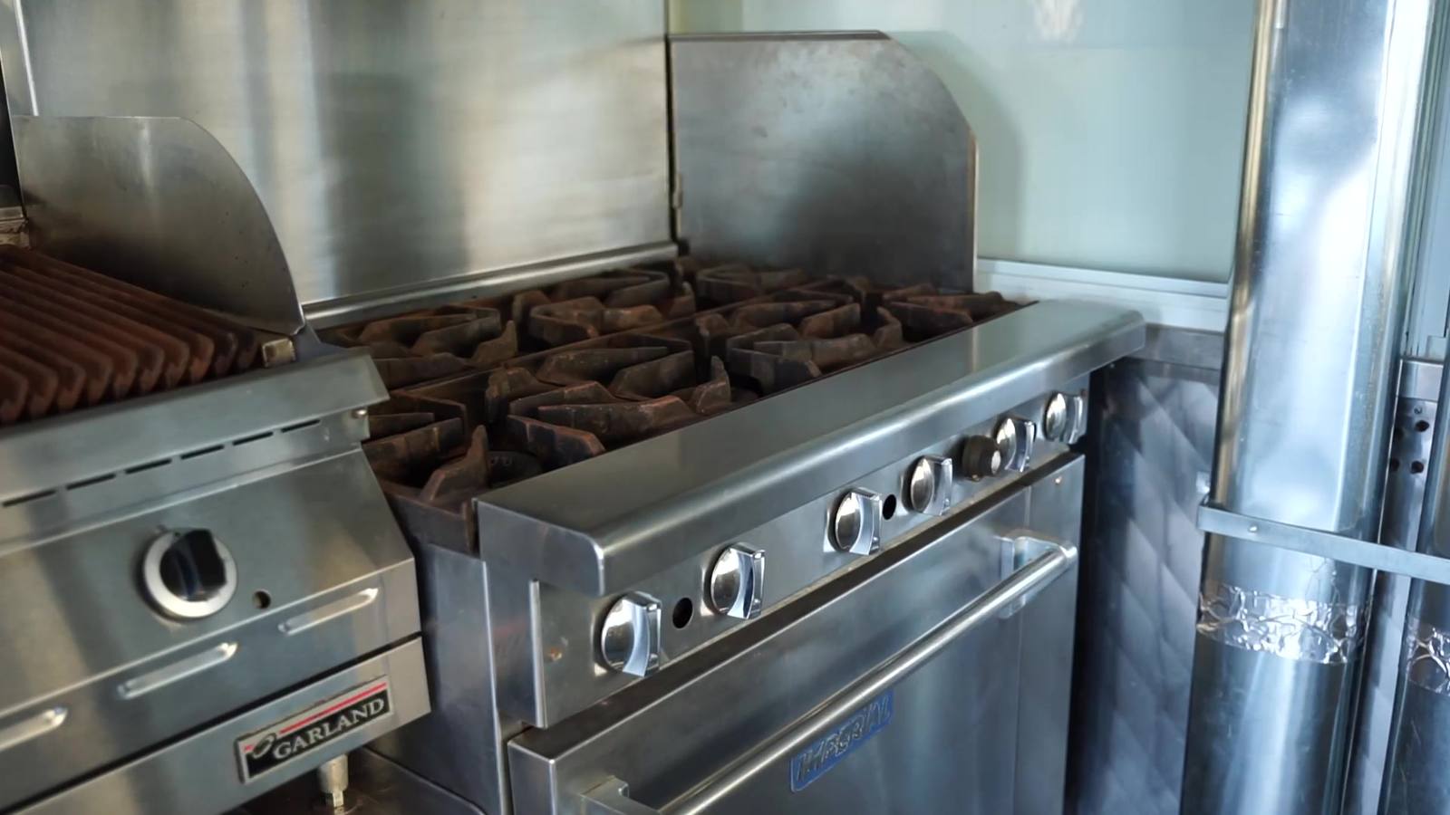 A char-grill and range inside a food trailer kitchen