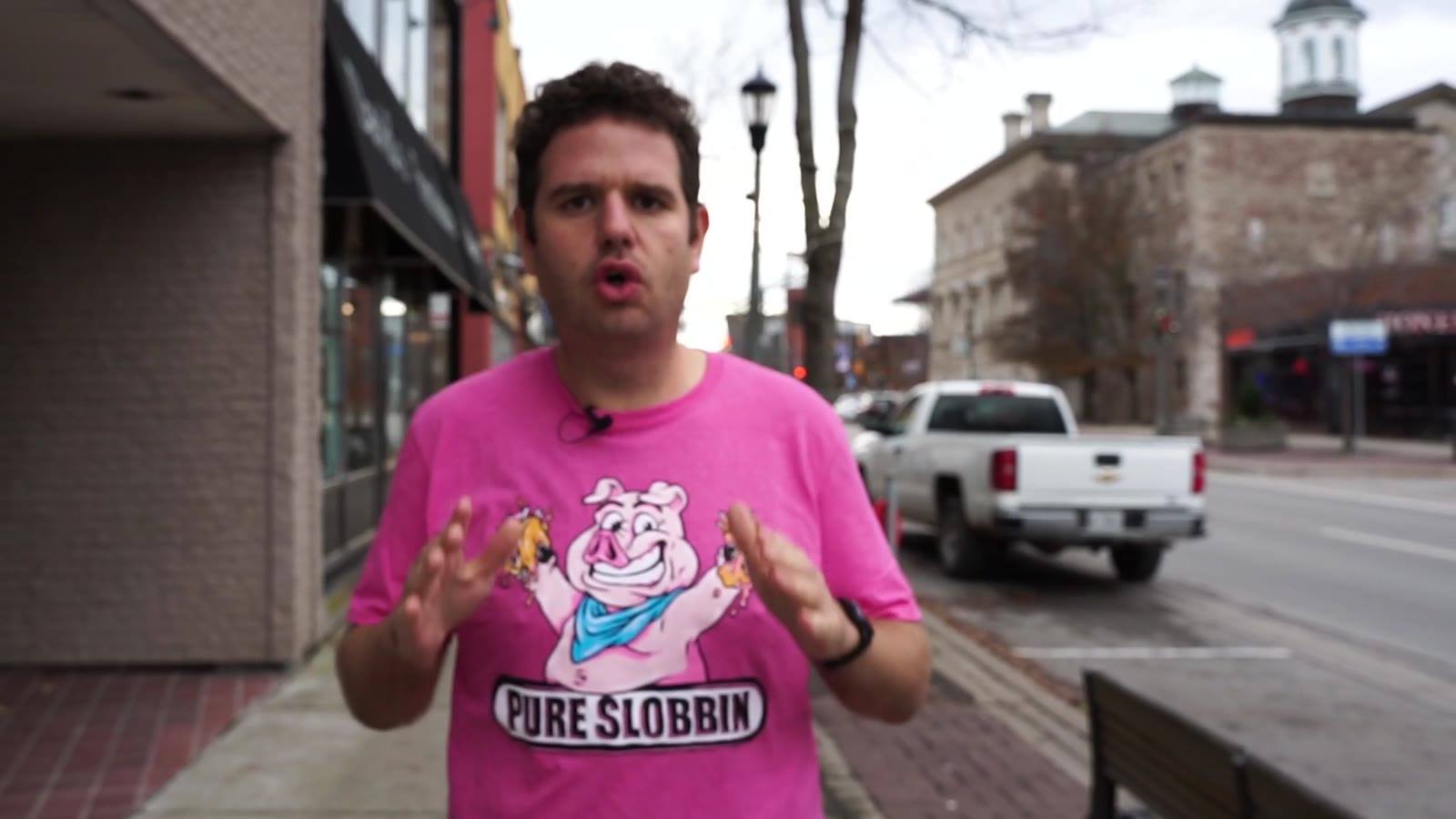 Joe in a pink Pure Slobbin' shirt on a downtown Welland street