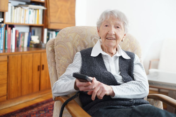 A senior lady enjoying aging in place safely and watching television