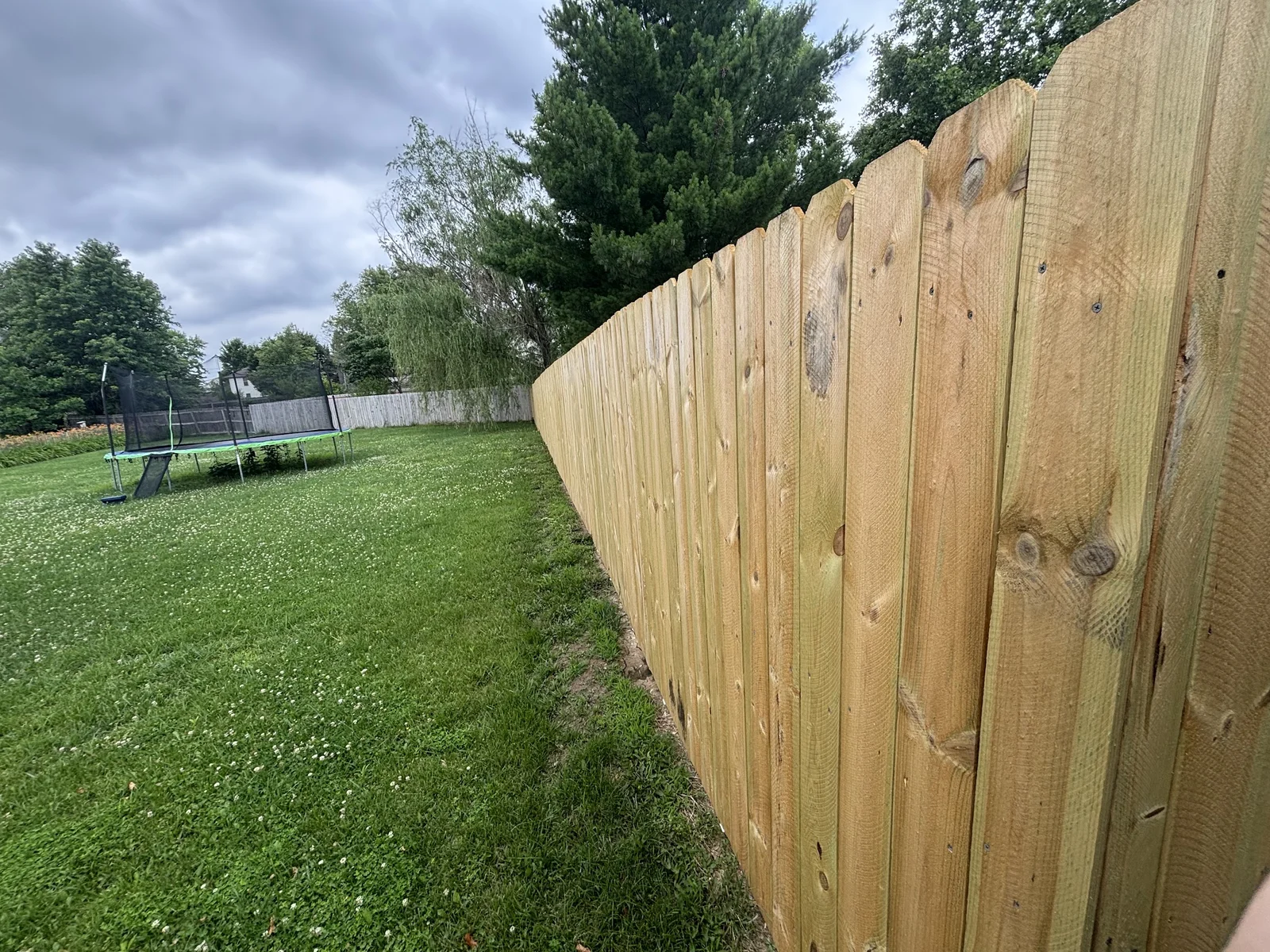 New wood privacy fence along a backyard in Columbia, MO, installed by Capstone Fencing Solutions