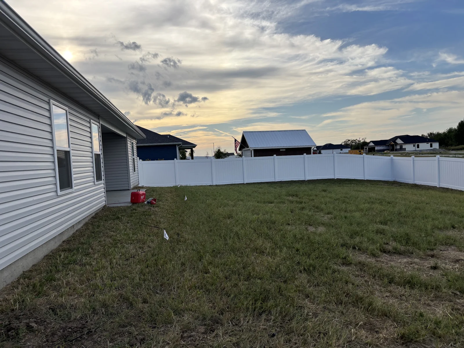 White vinyl privacy fence enclosing a new-build backyard in Columbia, MO