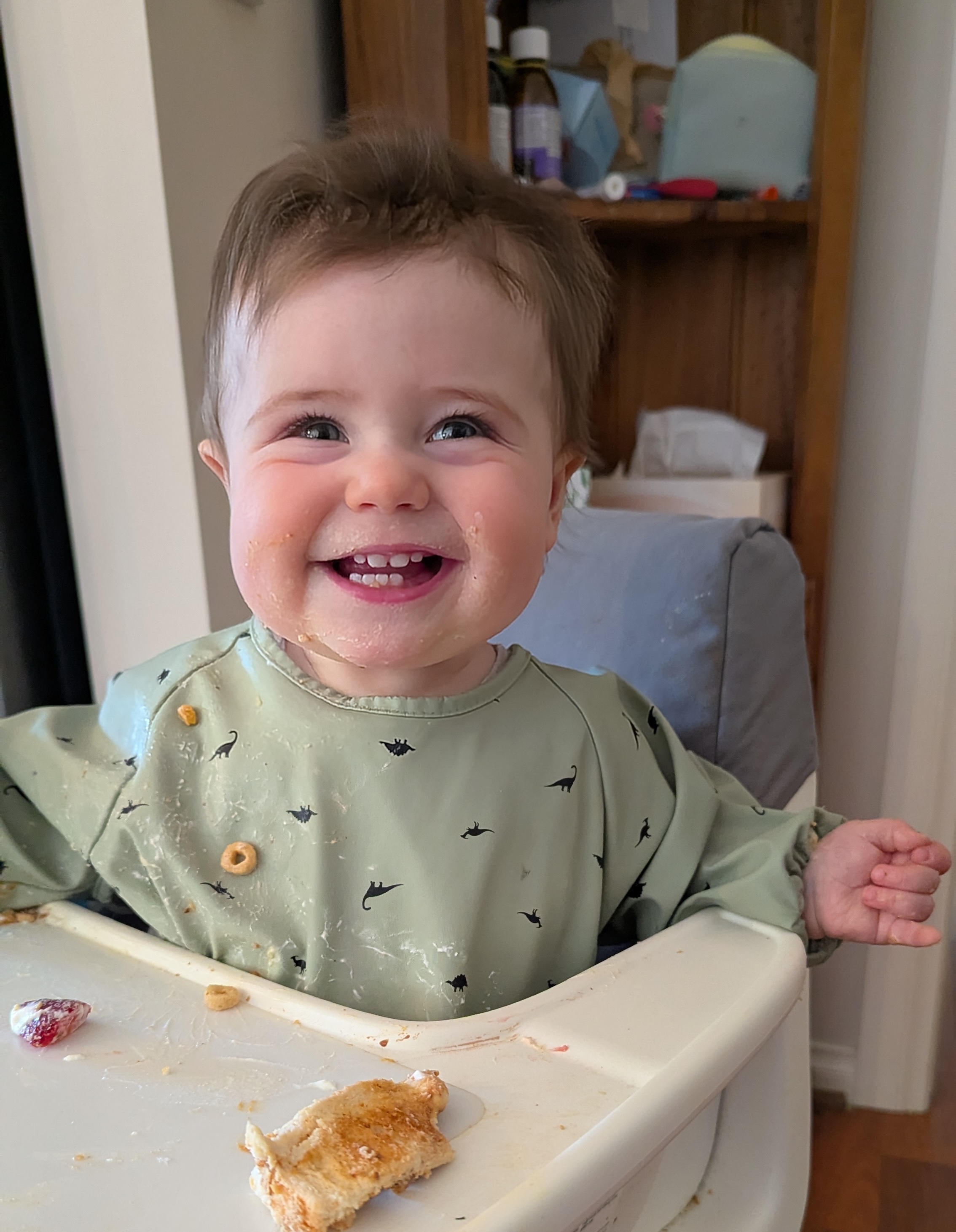 Hazel sitting in a highchair smiling