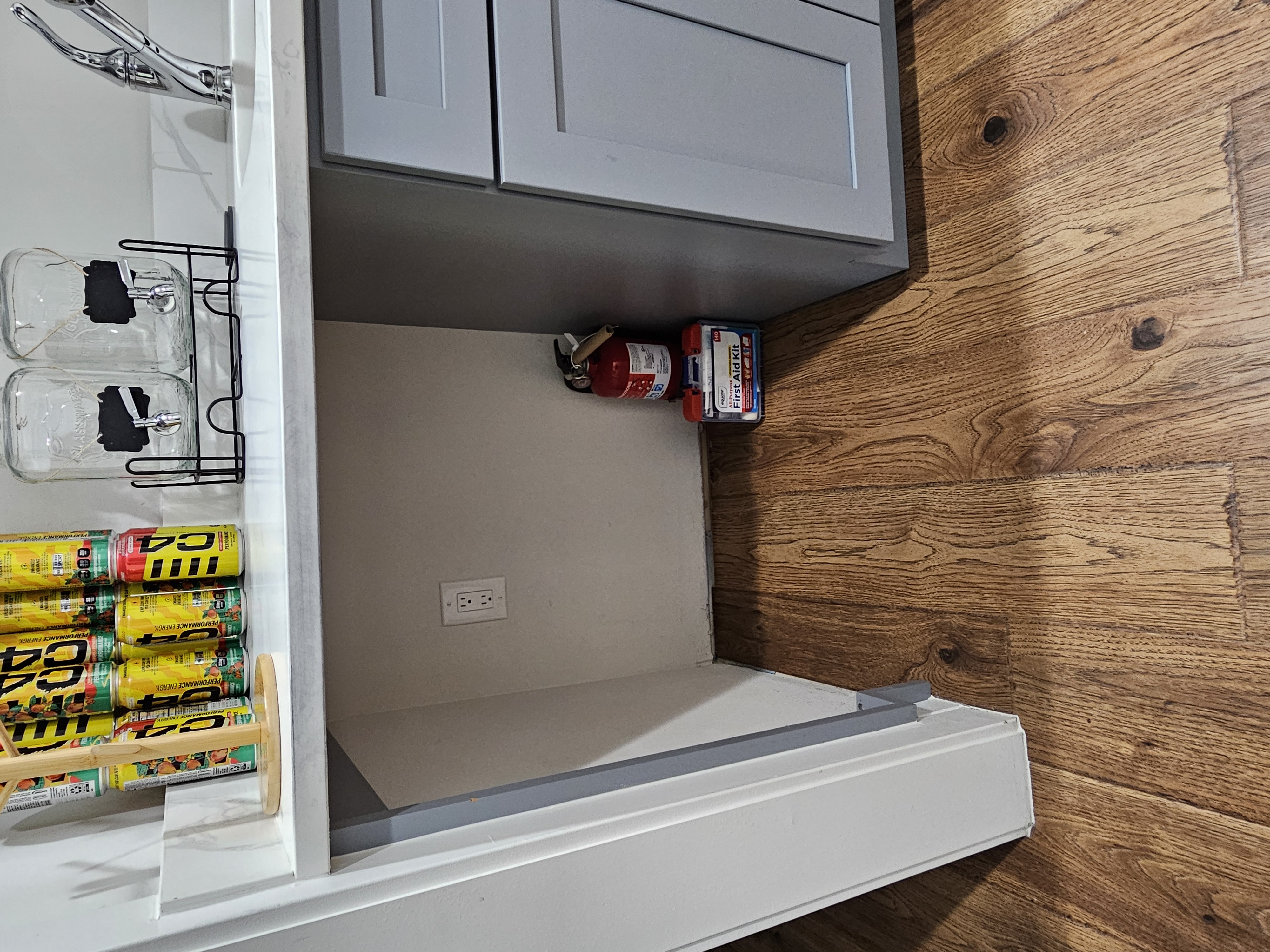 Fire extinguisher and first aid kit located under the coffee bar