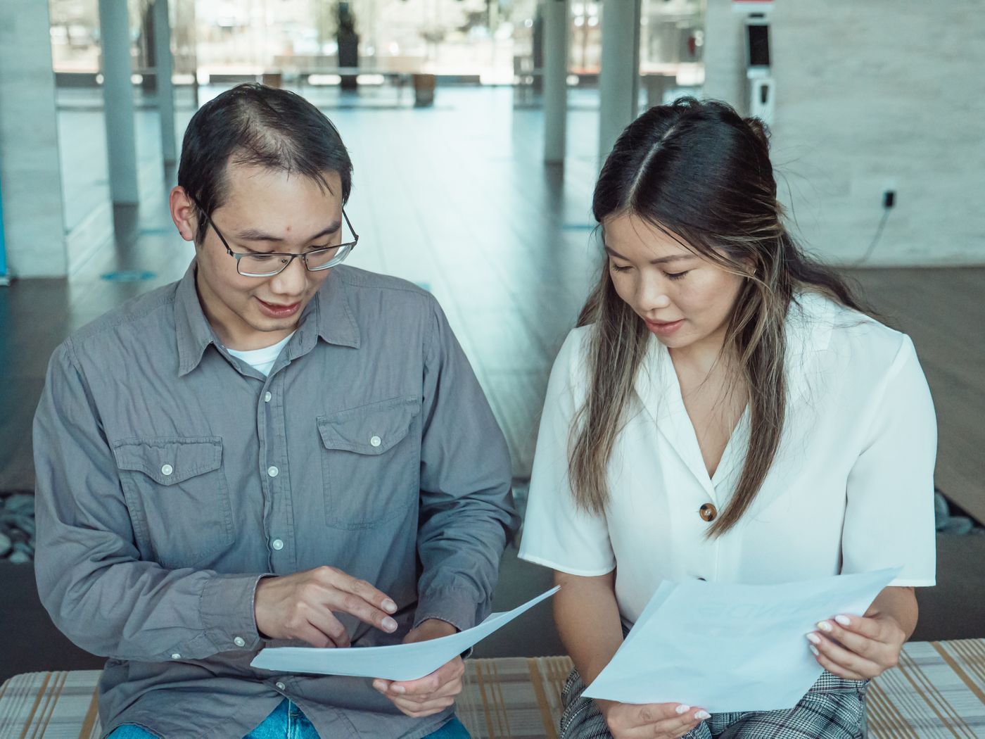 Two people reviewing business documents