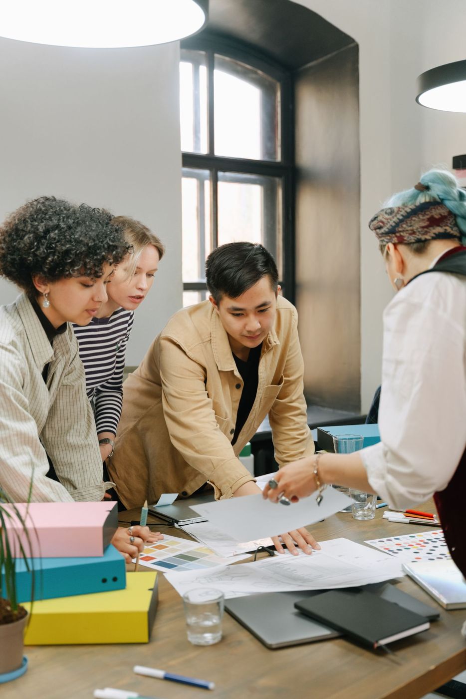 A team stacking hands over a table