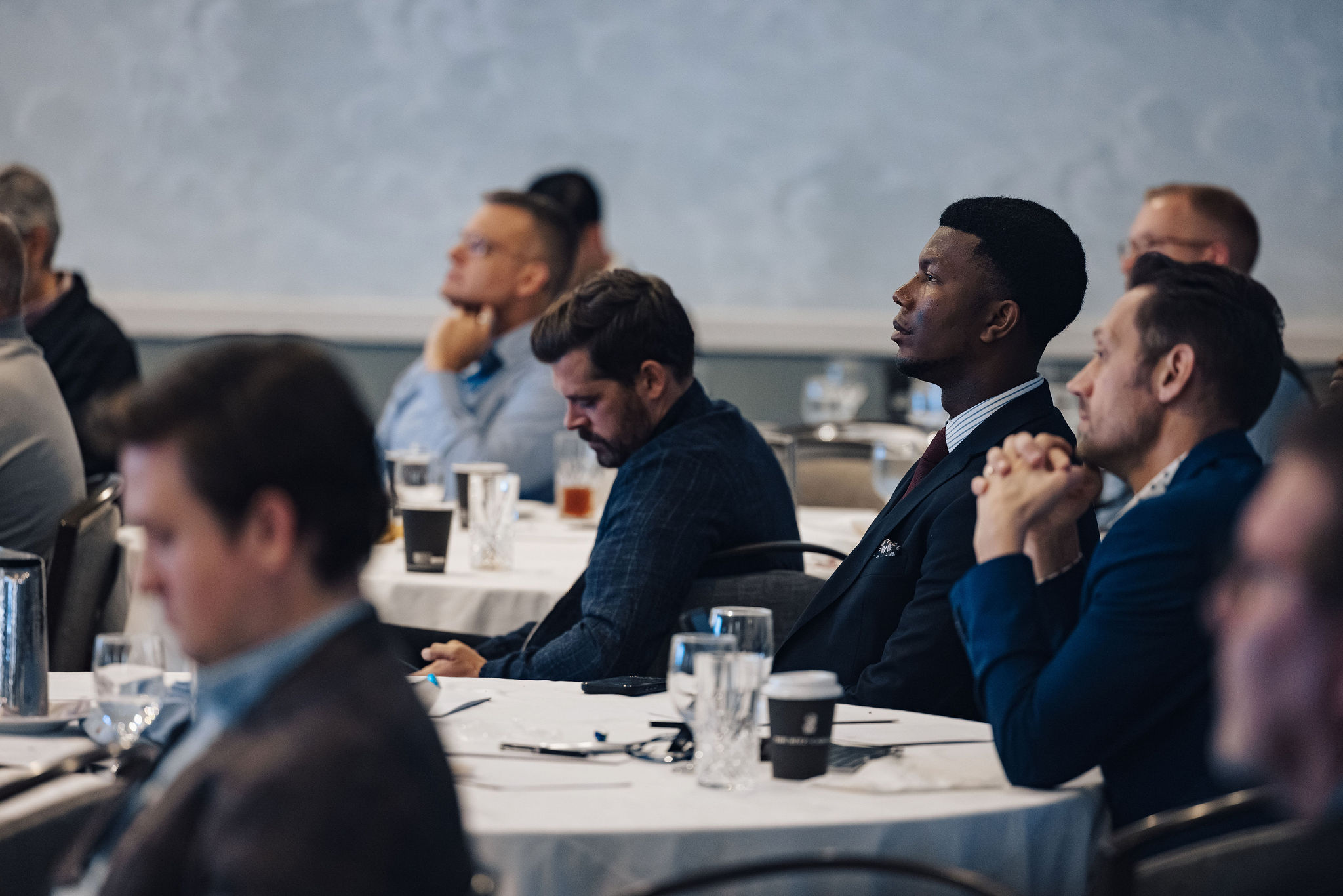 A group of people gathered around a table during a roundtable session.