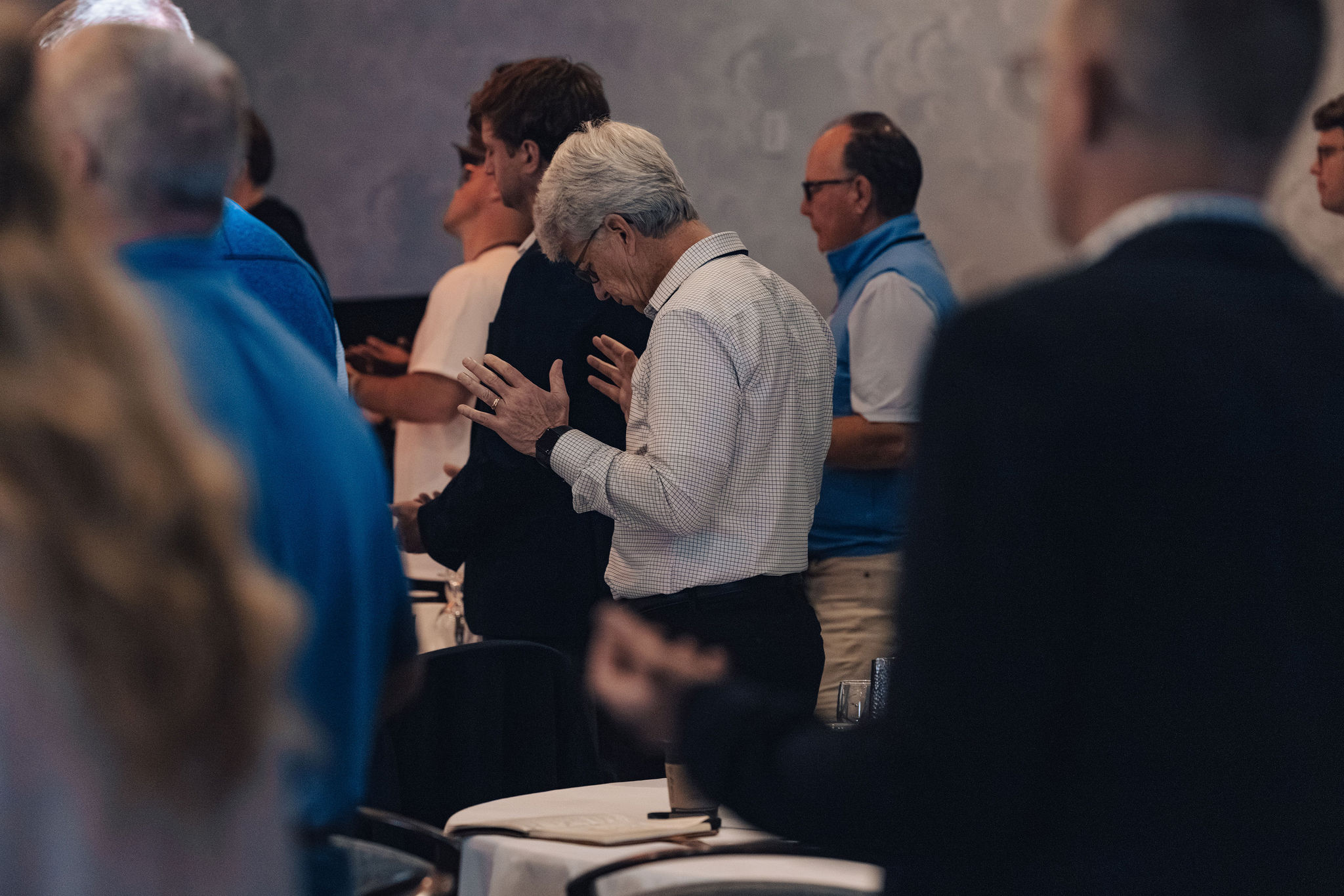 A small group of leaders in a quiet moment of prayer during a Friday call.