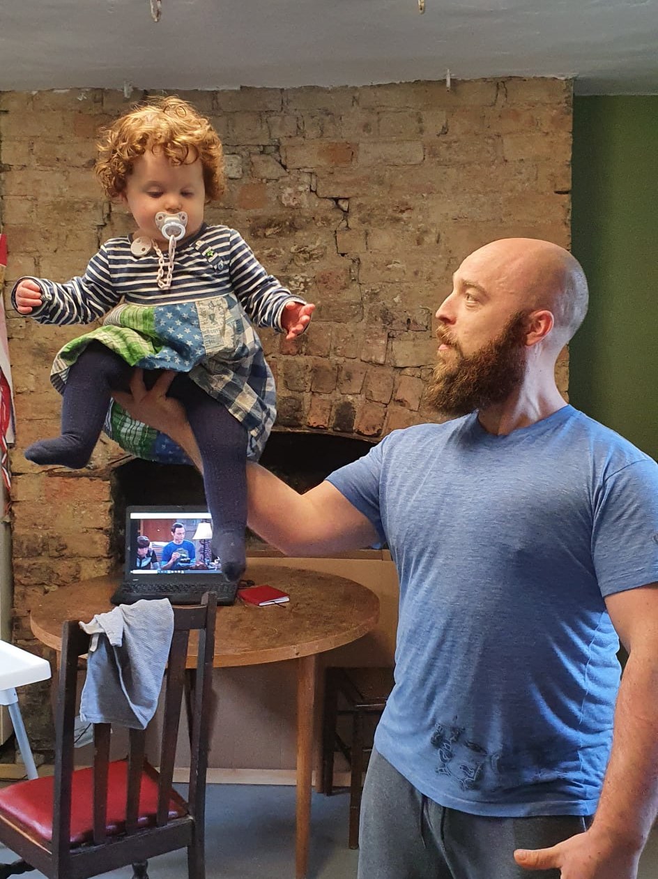 Will Walshe holding his daughter aloft one-handed