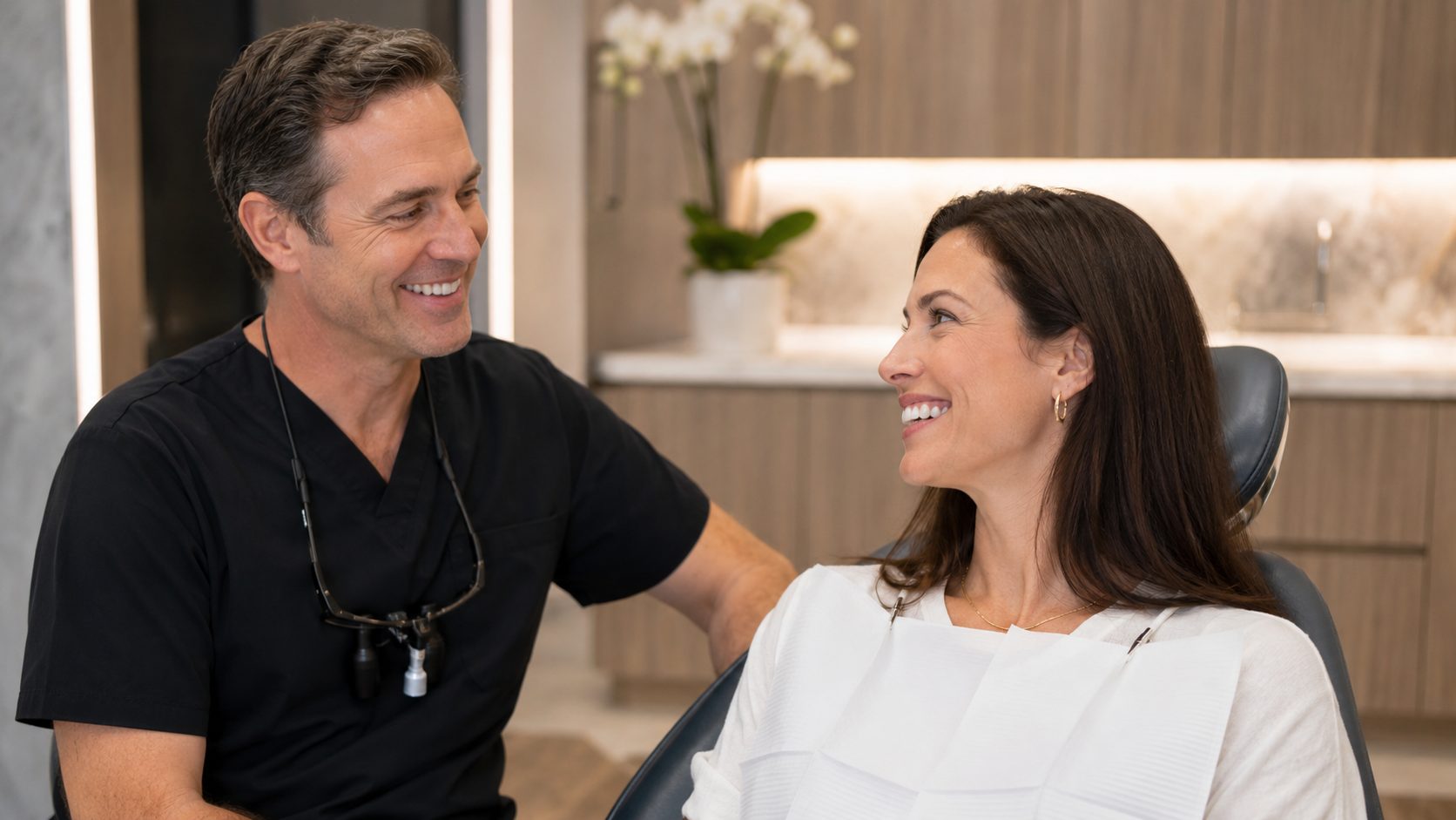 A dentist having a warm, reassuring conversation with a patient