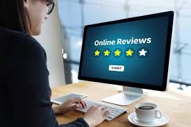 a person looking at a monitor that has the words Online Reviews on it