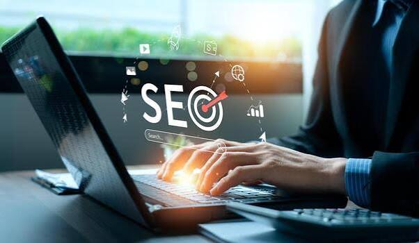 a person typing on a laptop with the word SEO floating in the universe a person typing on a laptop with the word SEO floating in the universe