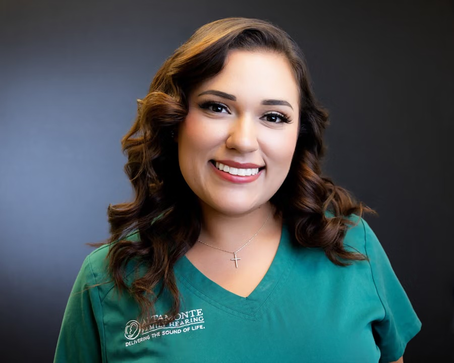 Francesca Natal smiling in green clinic scrubs
