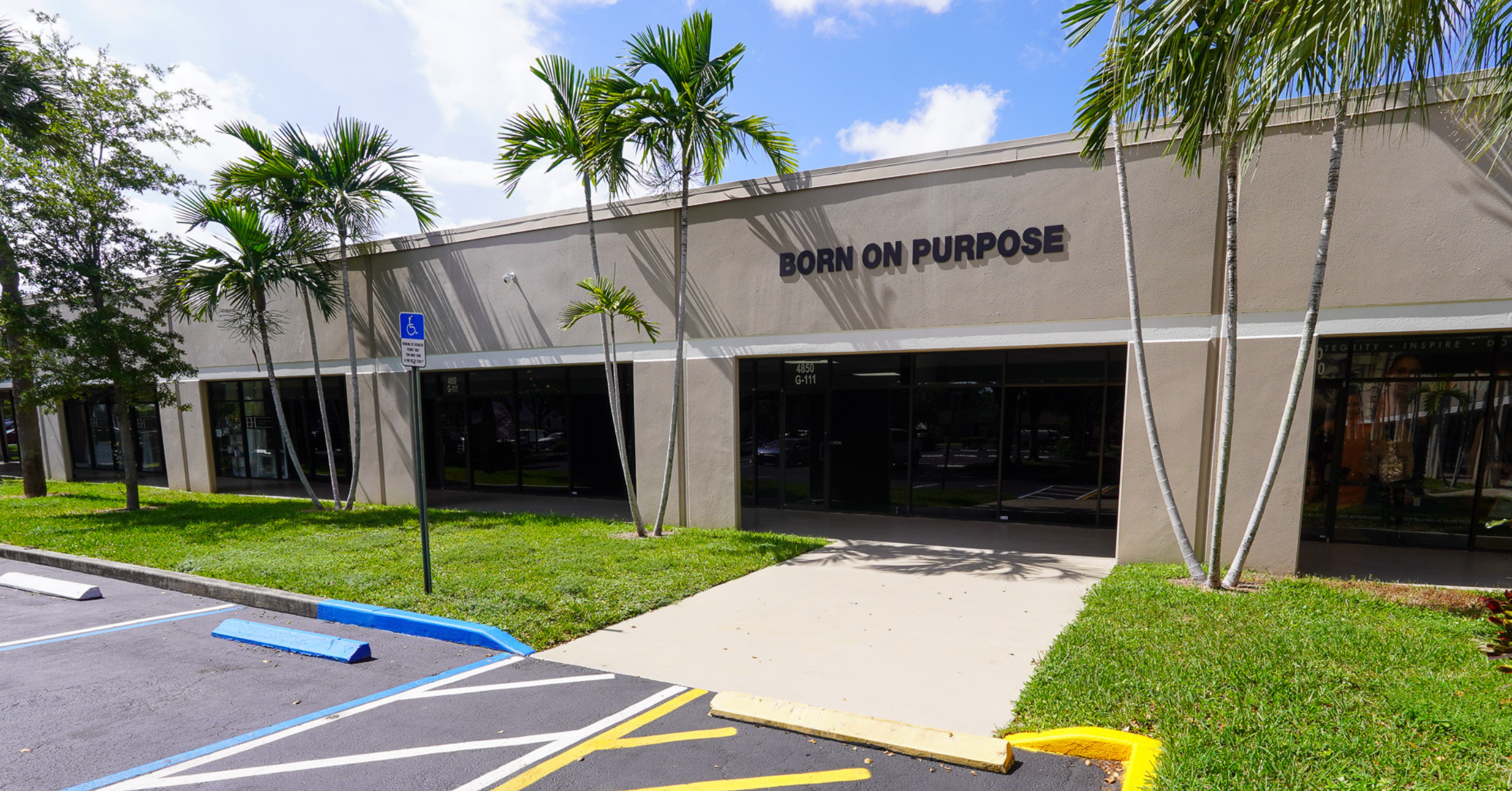 Born On Purpose Hub event venue in Lauderdale Lakes Florida exterior with parking, storefront entrance, and palm trees for event space rental
