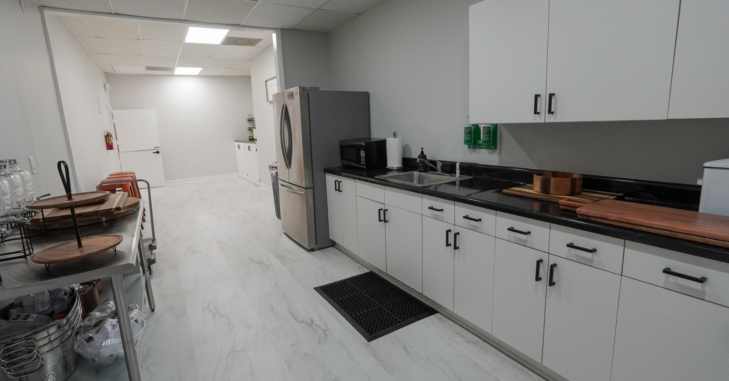 Prep kitchen at Born On Purpose Hub event space in Lauderdale Lakes FL with refrigerator sink and serving area for catering and event setup