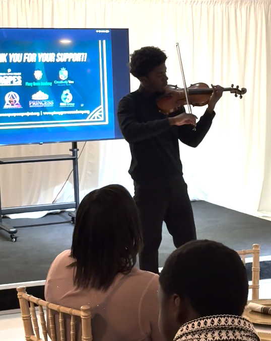 Violinist performing during Sunday Dinner hosted by The Born On Purpose Project, creating a meaningful atmosphere for youth mentorship, leadership development, community connection, and intentional fellowship in Broward County, Florida. Violinist performing during Sunday Dinner hosted by The Born On Purpose Project, creating a meaningful atmosphere for youth mentorship, leadership development, community connection, and intentional fellowship in Broward County, Florida.