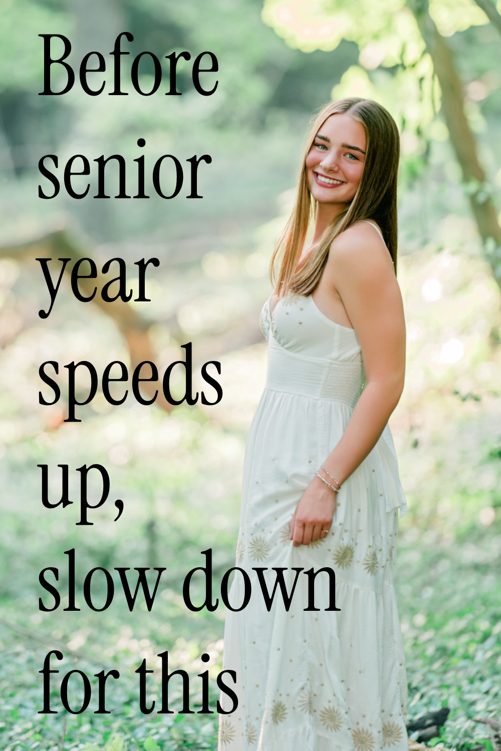 A teenage girl in a flowing ivory dress stands in a sunlit woodland clearing, smiling softly over her shoulder as golden light filters through the trees around her. Her long brown hair falls naturally against the delicate embroidered details of her dress, while the dreamy background blur and scattered greenery create a quiet, ethereal feeling—like a peaceful moment suspended between childhood and adulthood.