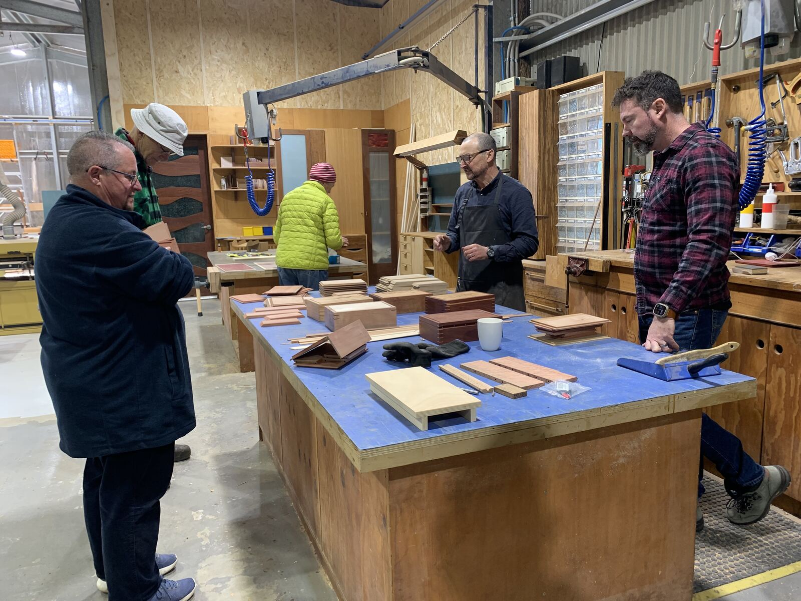 Gino showing sample boxes and timbers to the class