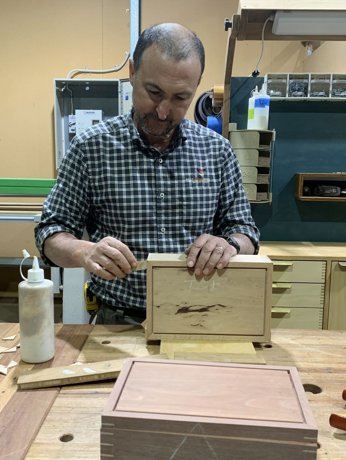 Gino gluing up a timber box at his bench