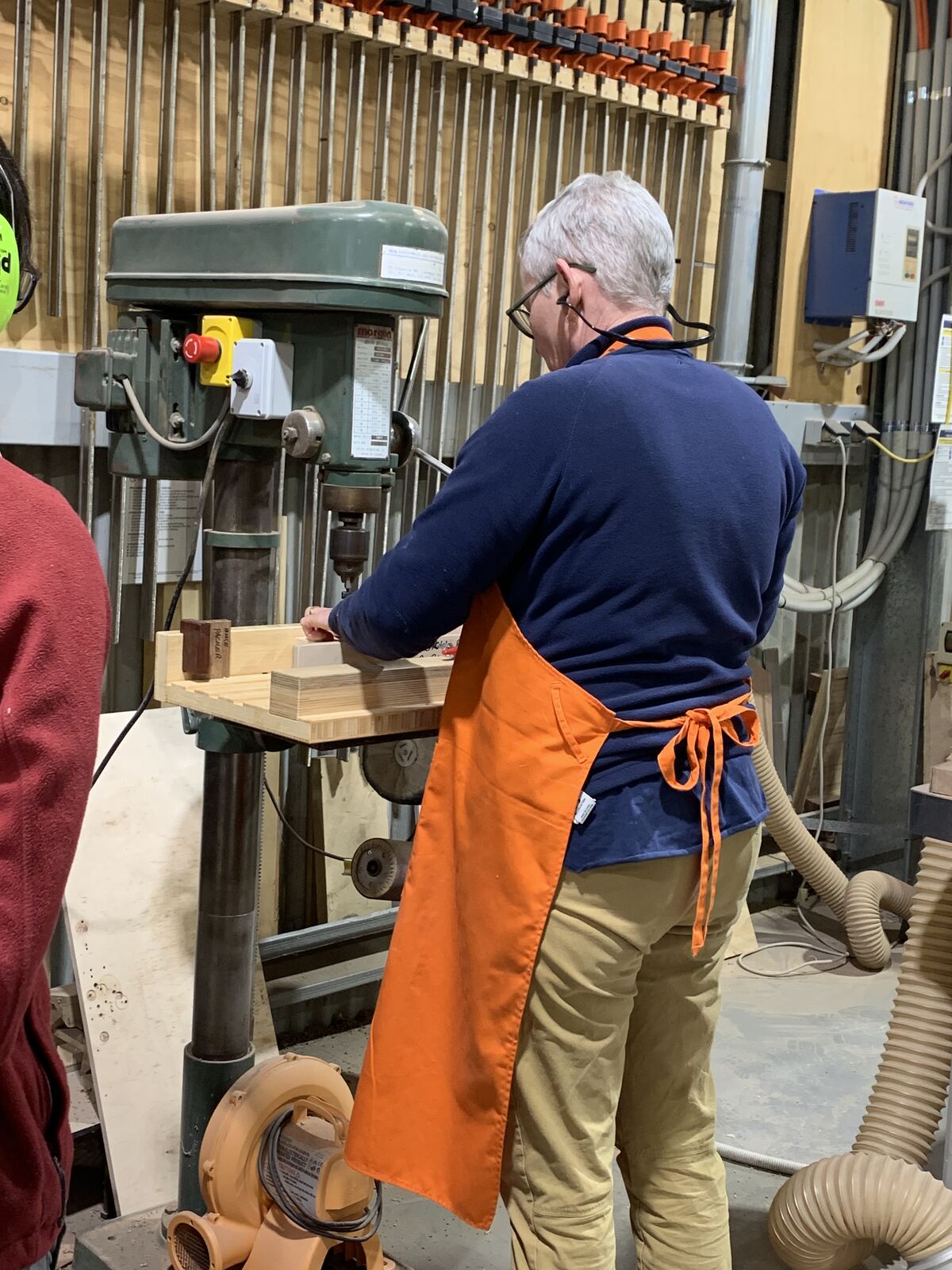 An attendee using the drill press