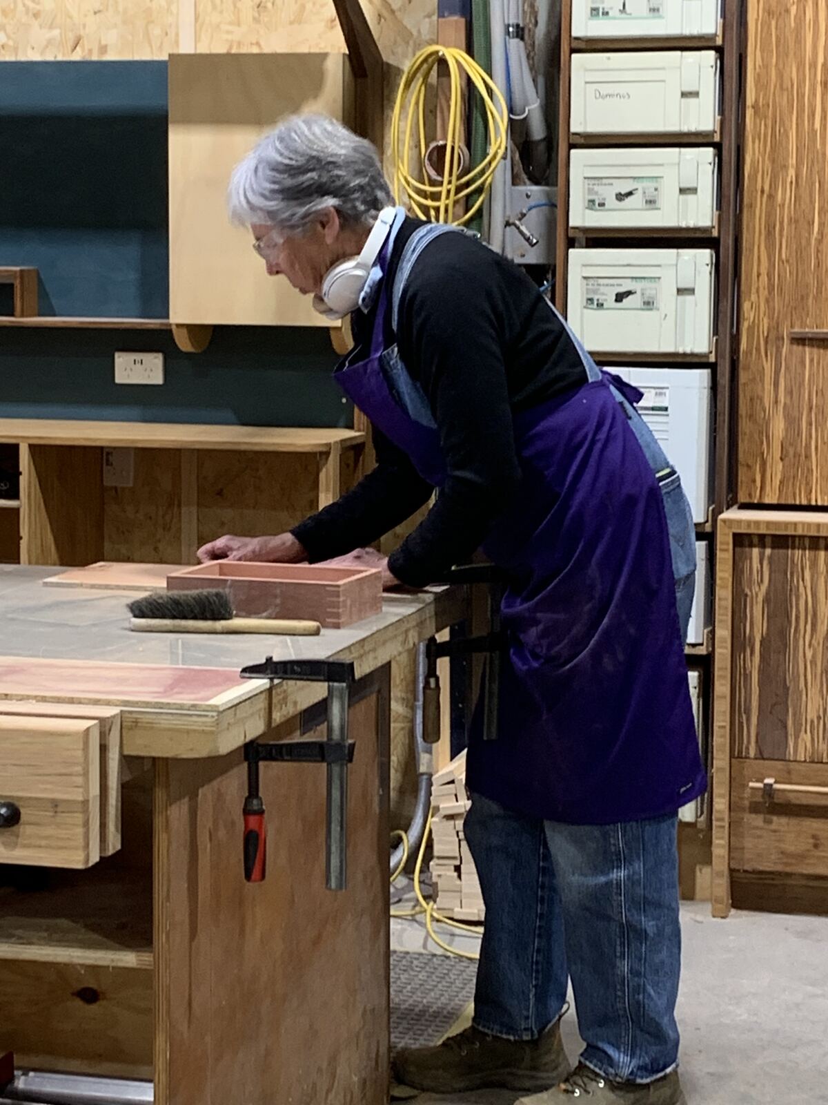 An attendee sanding her box at the bench