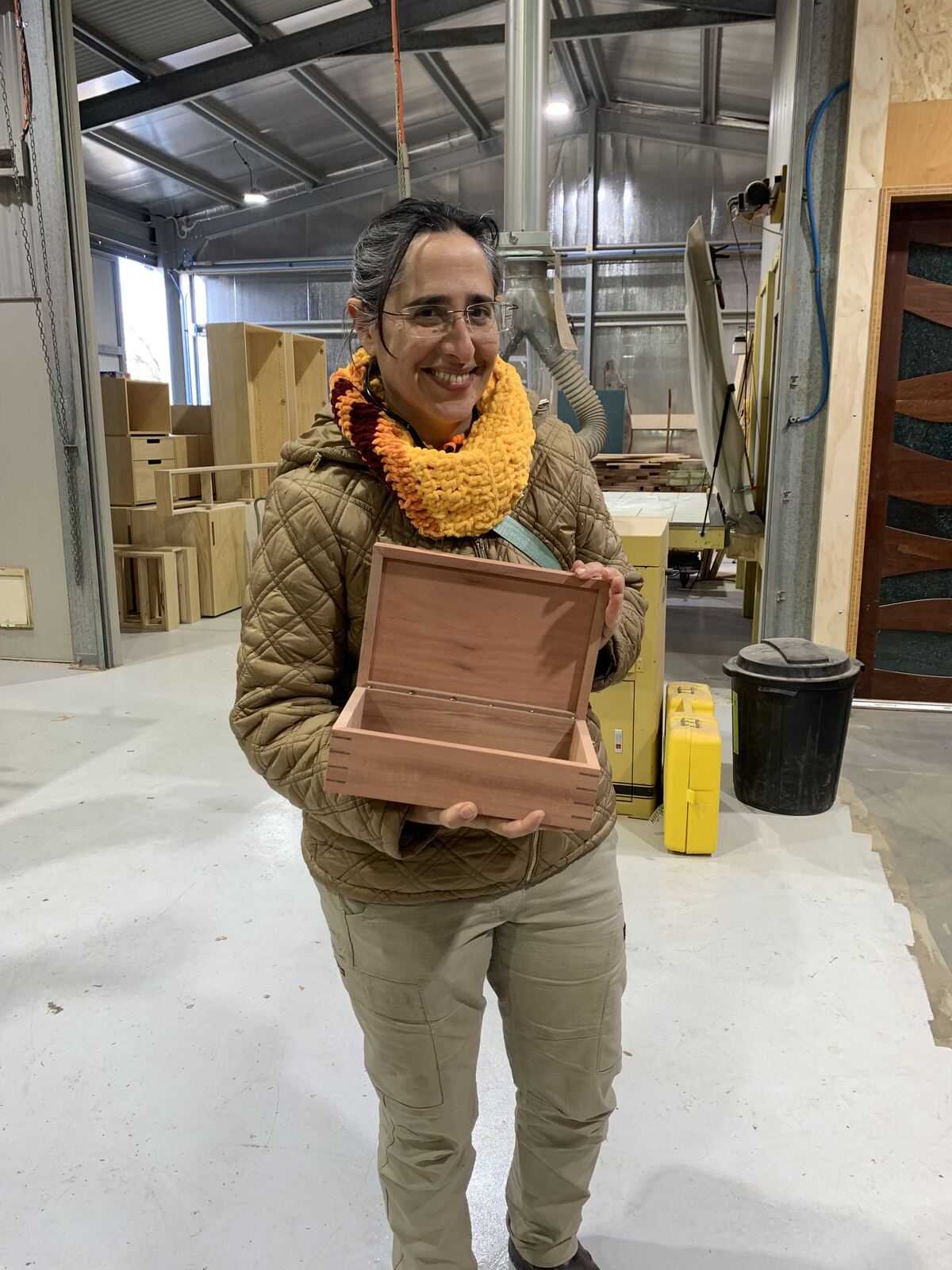 An attendee holding her finished box with the hinged lid open