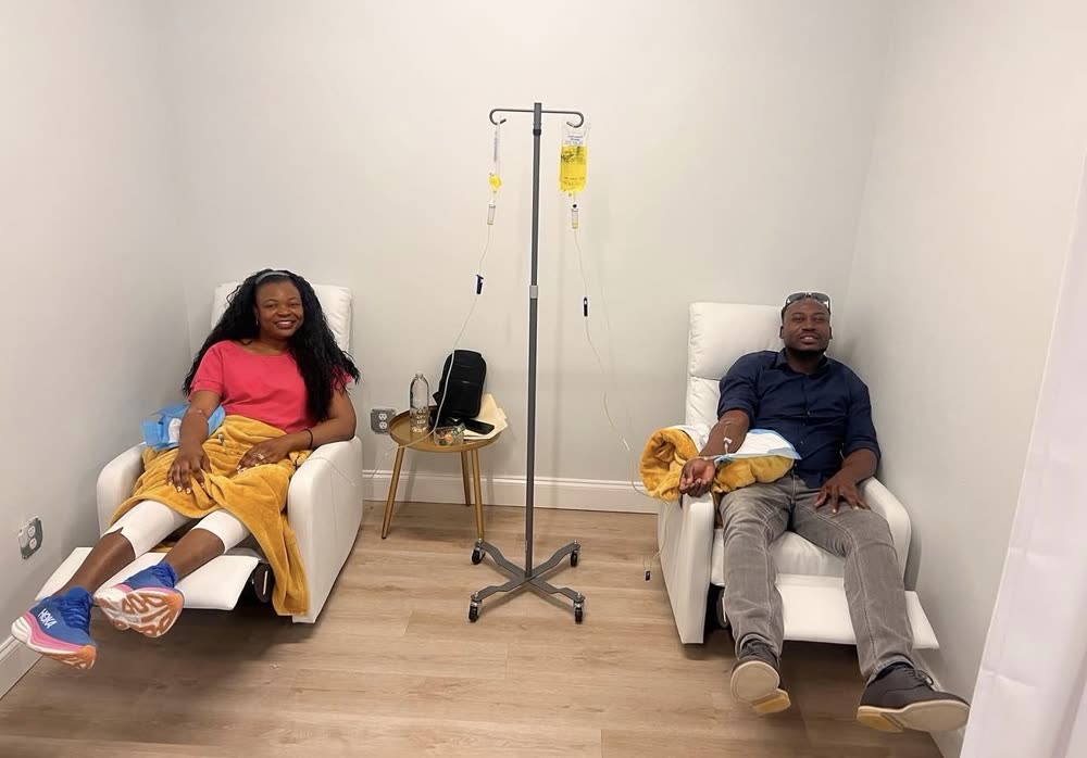 Two clients receiving IV hydration therapy in the private infusion room at Queens & Kings Wellness Lounge