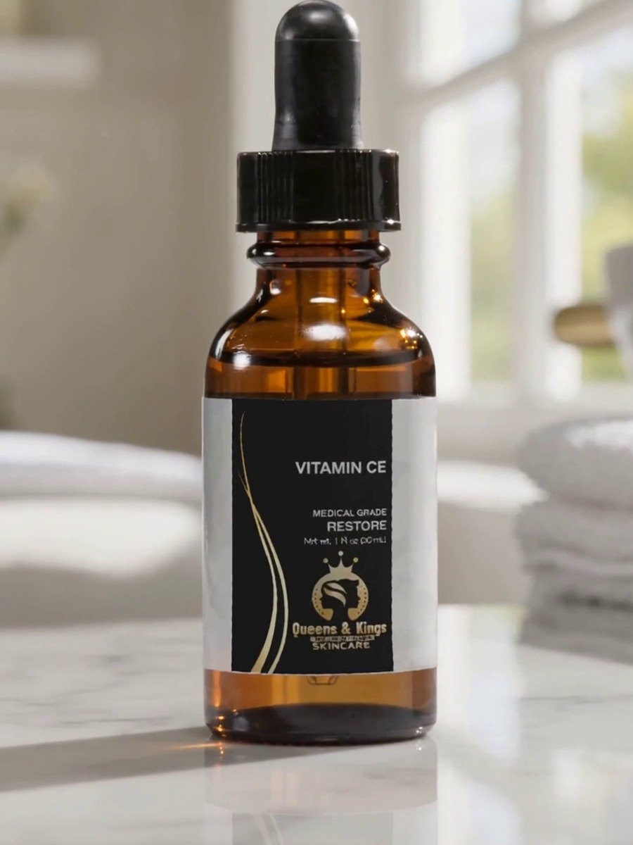 Queens & Kings Vitamin CE serum bottle with dropper on marble