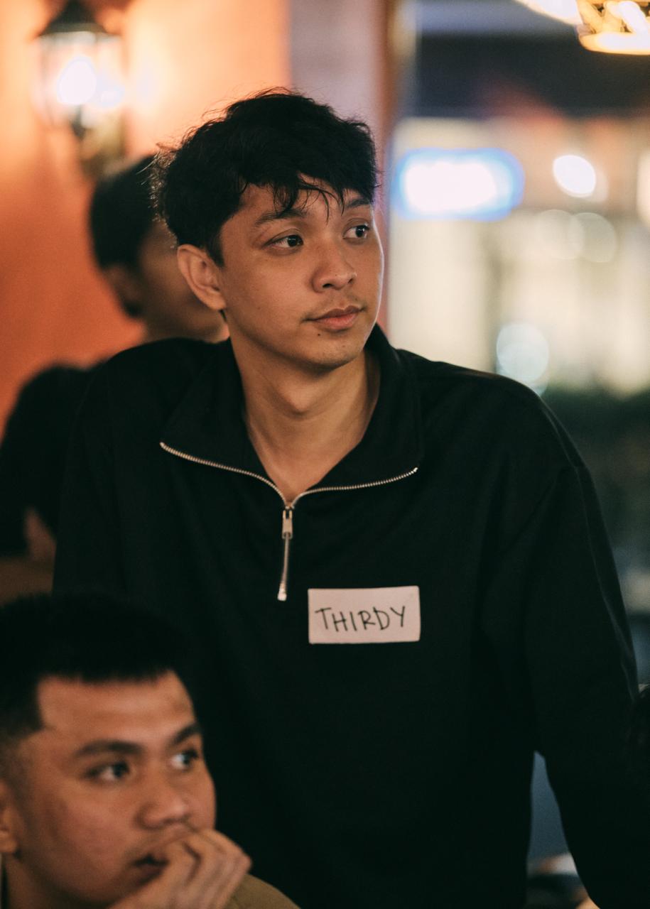 Thirdy Anolin working with his team