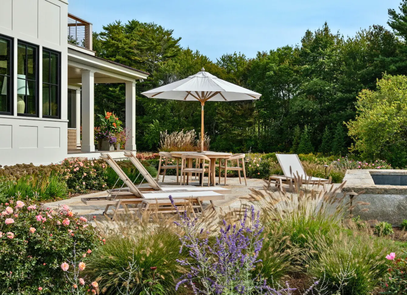 Exterior home painting by Minute Men Painters in Portsmouth, New Hampshire featuring a landscaped patio and outdoor seating area