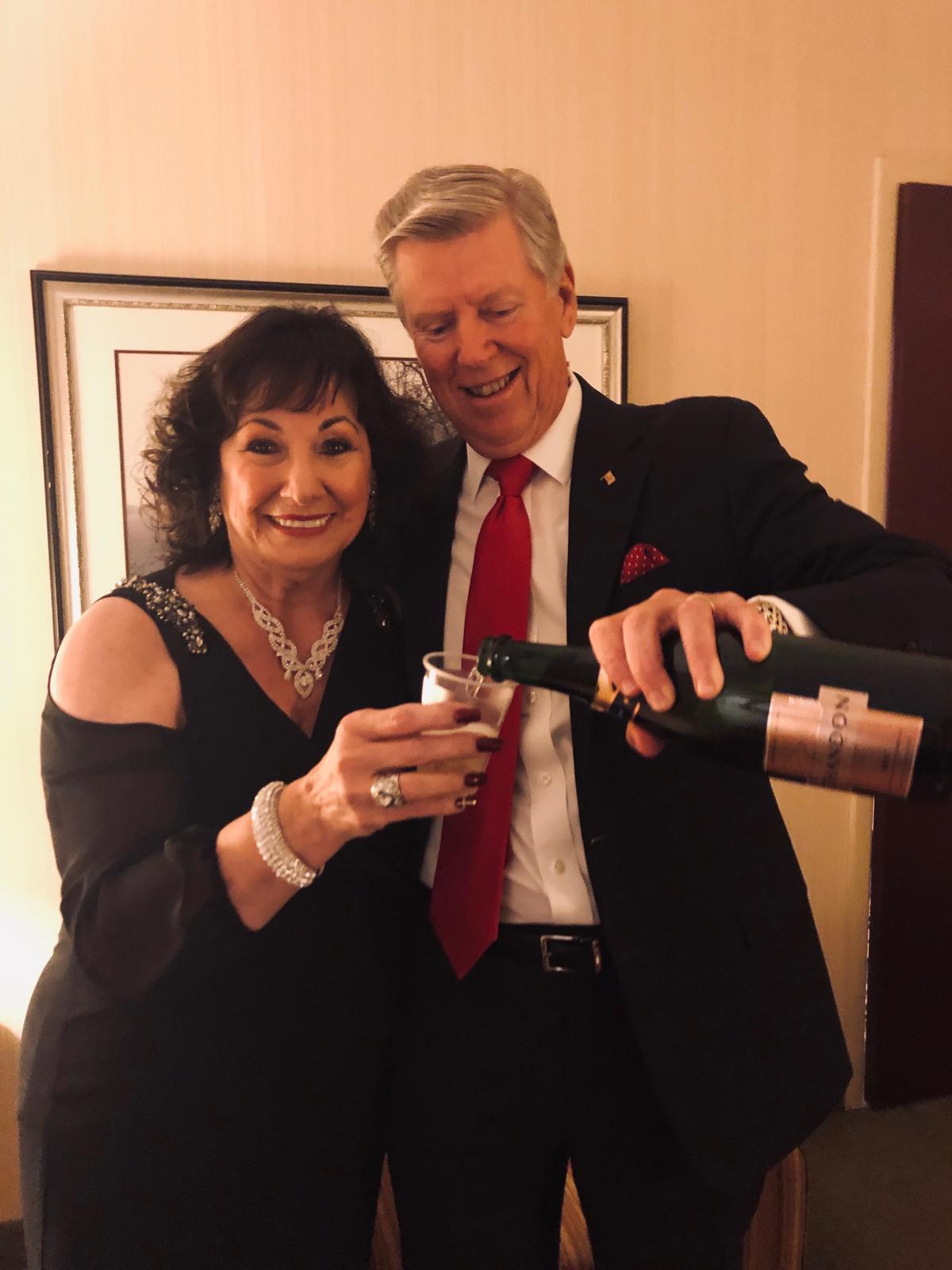 Earlene Vining raising a glass at an evening celebration